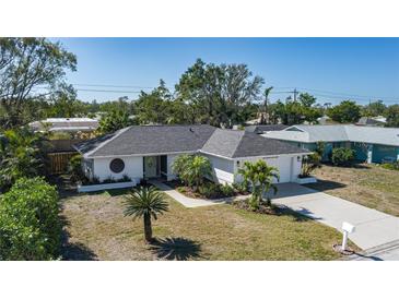 Charming single-story home with a well-maintained lawn and tropical landscaping at 6705 20Th W Ave, Bradenton, FL 34209