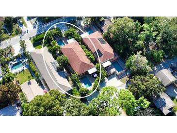 Stunning aerial view of two adjacent homes each featuring private pools and lush tropical landscaping for ultimate privacy at 2047 Roselawn St, Sarasota, FL 34231
