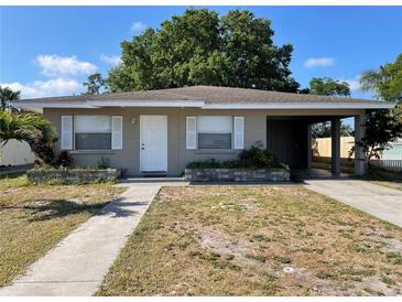 Charming single-story home featuring a covered carport and a walkway leading to the front door at 3305 13Th W Ave, Bradenton, FL 34205
