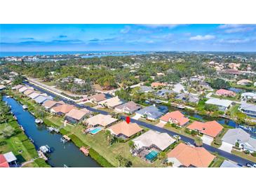 Waterfront neighborhood with beautiful landscaping, private docks, and swimming pools near lush greenery and ocean views at 104 Inlets Blvd # 104, Nokomis, FL 34275