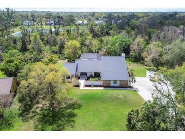 Aerial view of the home showcasing large lot, mature trees, and plenty of privacy at 3651 Walden Pond Dr, Sarasota, FL 34240