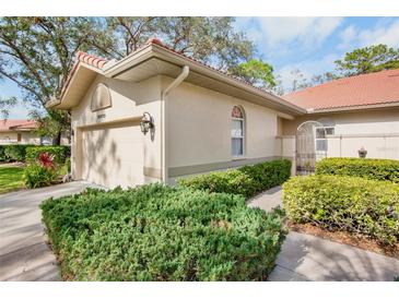 Charming home featuring a red tile roof, a meticulously manicured yard, and an attached garage at 3370 E Chelmsford Ct # 49, Sarasota, FL 34235