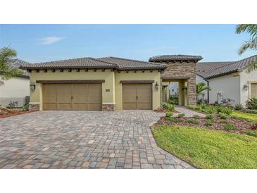 Charming single-Gathering home featuring a two-car garage, tile roof, and a beautifully paved driveway at 428 Bocelli Dr, North Venice, FL 34275