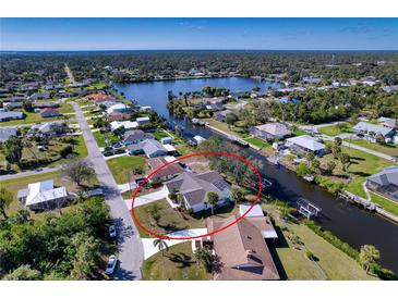 Inviting canal-front home with a private dock, perfect for boating and enjoying waterfront living at 18576 Alphonse Cir, Port Charlotte, FL 33948