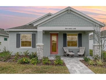 Charming single-story home featuring a cozy front porch and well-maintained landscaping at 1944 Vang Ln, Sarasota, FL 34240