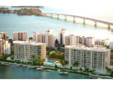 Stunning aerial view of waterfront condos, a bridge, and a scenic coastline at 550 Golden Gate Point # 701, Sarasota, FL 34236