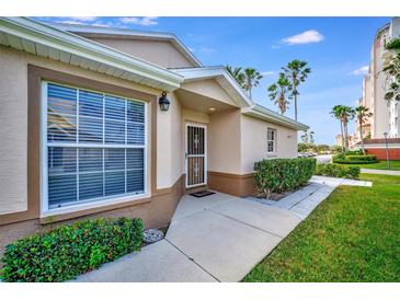 Inviting home exterior featuring a well-manicured lawn and a welcoming front entrance and large window at 2908 Captains Ct # 20, Palmetto, FL 34221