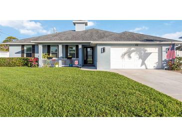 Charming single-story home featuring lush green lawn, inviting front porch and attached two-car garage at 432 W Gate Dr, Venice, FL 34285