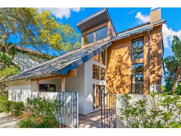 Stunning contemporary home featuring unique architectural details, private gated entry, and lush landscaping at 5236 Siesta Cove Dr, Sarasota, FL 34242