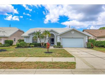 Charming single-story home with well-manicured lawn, mature palms, and a two-car garage at 6409 Stone River Rd, Bradenton, FL 34203