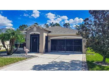 Charming home with landscaped front yard, screened garage, and inviting entrance at 9043 39Th Street E Cir, Parrish, FL 34219