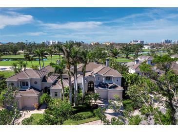Stately home with lush landscaping and a tiled roof, situated on a golf course with city views at 2065 Harbour Links Dr # 5, Longboat Key, FL 34228