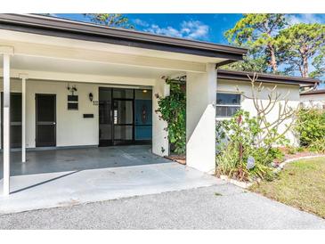 Inviting front entrance with covered parking and landscaping at 6124 Green View Dr # 139, Sarasota, FL 34231