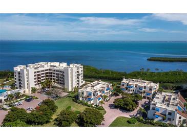 Stunning aerial view of waterfront condos with lush landscaping and tranquil bay views at 2012 Harbourside Dr # 2104, Longboat Key, FL 34228