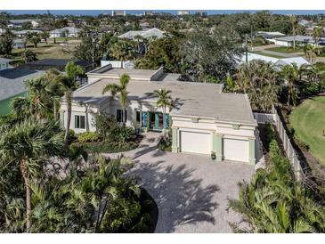 Stunning home with lush landscaping, brick driveway and attached two-car garage, and decorative front door at 333 Bayshore Dr, Venice, FL 34285