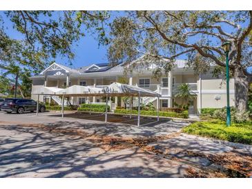 Inviting condominium with covered parking, lush landscaping, and charming balconies at 3803 54Th W Dr # 203, Bradenton, FL 34210