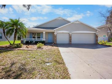 Charming single-story home featuring a three-car garage, covered porch, and well-maintained landscaping at 4110 Noble Pl, Parrish, FL 34219