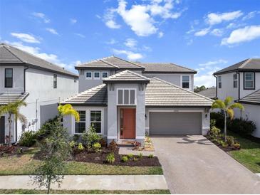 Beautiful two-story home featuring a well-manicured lawn and a two-car garage at 4793 Antrim Dr, Sarasota, FL 34240