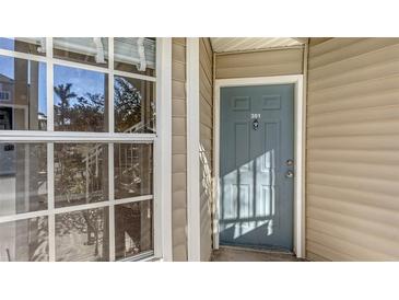 Close-up of a unit's front door with house number and a window showing the reflection of trees at 850 S Tamiami Trl # 301, Sarasota, FL 34236