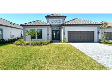 Beautiful, well-maintained home with manicured lawn and lovely landscaping at 552 Bocelli Dr, North Venice, FL 34275