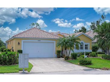 Charming single-story home featuring a well-manicured lawn and a two-car garage at 8503 Gateway Ct, Englewood, FL 34224