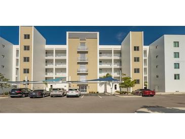 Exterior view of a modern condo building with multiple balconies and covered parking at 1709 N Tamiami Trl # 408, Sarasota, FL 34234