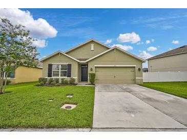 Inviting single-story home with a well-manicured lawn and a two-car garage at 2417 Sand Gables Trl, Bradenton, FL 34208