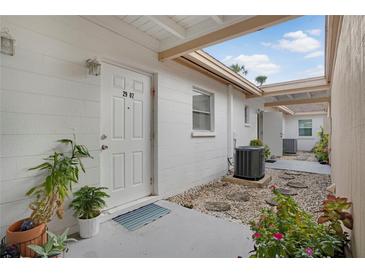 Charming entrance with white door, number 2907, stone pavers, and garden plants in view at 2907 51St W Ave, Bradenton, FL 34205