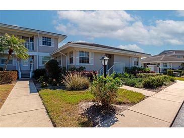 Condo exterior shows meticulous landscaping around building with neutral color scheme and white trim at 617 Estuary Dr # 617, Bradenton, FL 34209
