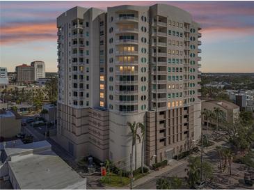 Luxury high-rise condo building with unique architecture, balconies, and city views at sunset at 1771 Ringling Blvd # 1001, Sarasota, FL 34236