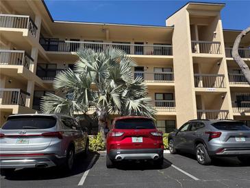 A multi-story condominium complex with ample parking on a sunny day at 435 30Th W Ave # D303, Bradenton, FL 34205