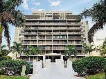 Exterior view of this large condominium building with multiple balconies and beautifully landscaped surroundings at 500 N Osceola Ave # 203, Clearwater, FL 33755