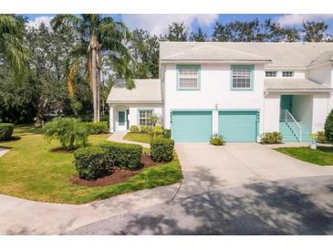 Charming two-story townhouse with light blue trim, a two-car garage, and a well-manicured lawn at 6639 Pineview Ter # 6639, Bradenton, FL 34203