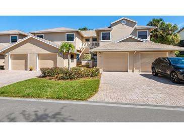 Inviting townhome with a two-car garage and beautiful brick paved driveways at 1718 Starling Dr # 104, Sarasota, FL 34231