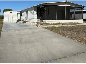Charming single-story home featuring a screened porch and convenient driveway at 197 Palm Harbor Dr, North Port, FL 34287