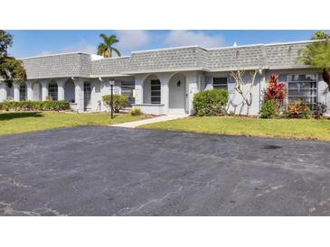Charming villa with well-manicured landscaping and a spacious driveway on a sunny day at 4104 35Th W Ave, Bradenton, FL 34205