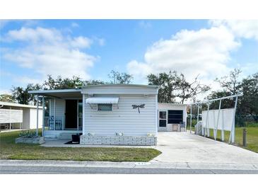 Charming single-story home with a well-maintained front yard and long driveway at 415 Oakwood E Blvd, Sarasota, FL 34237