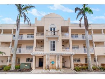 Exterior building view featuring well-maintained landscaping, beautiful balconies, and detailed architecture at 5970 Midnight Pass Rd # 177, Sarasota, FL 34242