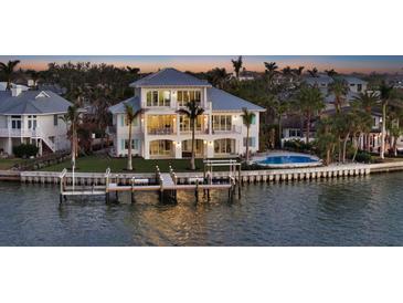 Waterfront home boasts private dock, pool, and spacious balcony overlooking serene waters, perfect for luxury living at 1300 Tangier Way, Sarasota, FL 34239