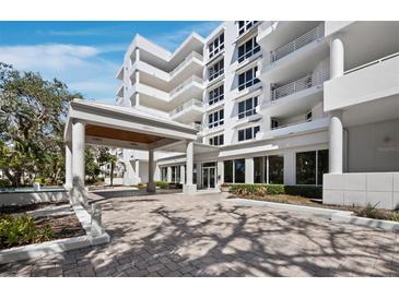 Beautiful condominium building with a covered entrance for easy drop-off on a sunny day at 2410 Harbourside Dr # 121, Longboat Key, FL 34228