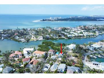 Stunning aerial view of waterfront property with bay access and lush surroundings at 4114 Roberts Point Cir, Sarasota, FL 34242