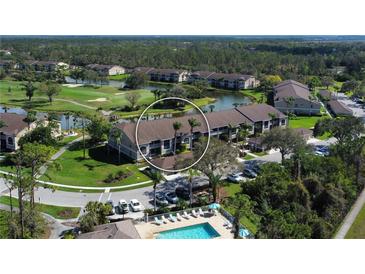 Aerial view of condo community with pool, golf course, and lakes at 5320 Hyland Hills Ave # 2222, Sarasota, FL 34241