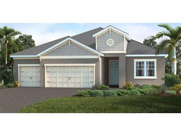 Charming one-story home features a three-car garage, manicured lawn, and a welcoming covered entrance at 18771 Toulon Ct, Venice, FL 34293