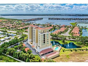 Luxury condo building boasts waterfront views, a pool, lush landscaping, and convenient parking for upscale living at 501 Haben Blvd # 204, Palmetto, FL 34221