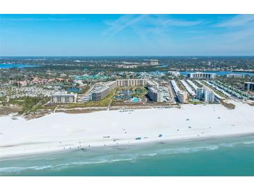 Discover resort-style living with beach access, a pool, and a lake in a beautiful condo community from an aerial view at 5780 Midnight Pass Rd # 210, Sarasota, FL 34242