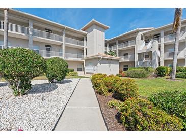 Beautiful condo building exterior featuring balconies, well-maintained landscaping, and a welcoming walkway at 9630 Club South Cir # 6208, Sarasota, FL 34238