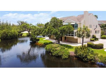 Beautiful waterfront property with lush landscaping and private dock at 121 Tidy Island Blvd, Bradenton, FL 34210