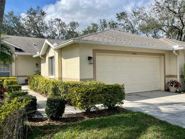 Charming one-story home featuring manicured landscaping and an attached two-car garage at 5712 Cottonwood St, Bradenton, FL 34203