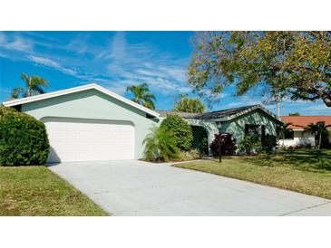 Charming single-story home with a well-maintained lawn and a two-car garage, presenting a welcoming curb appeal at 7208 13Th W Ave, Bradenton, FL 34209