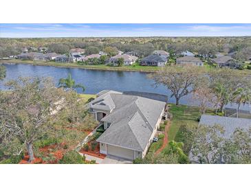 Beautiful home with a screened-in lanai overlooking a tranquil lake, enhancing outdoor living at 11910 Soft Rush Ter, Lakewood Ranch, FL 34202